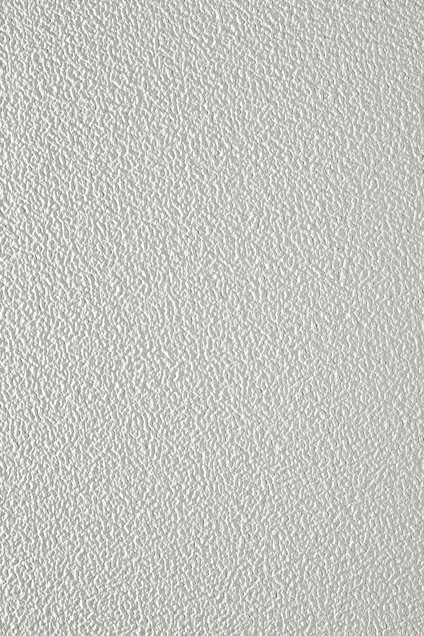 Strukturerad, vit yta med ett mönster av små upphöjningar över hela området.