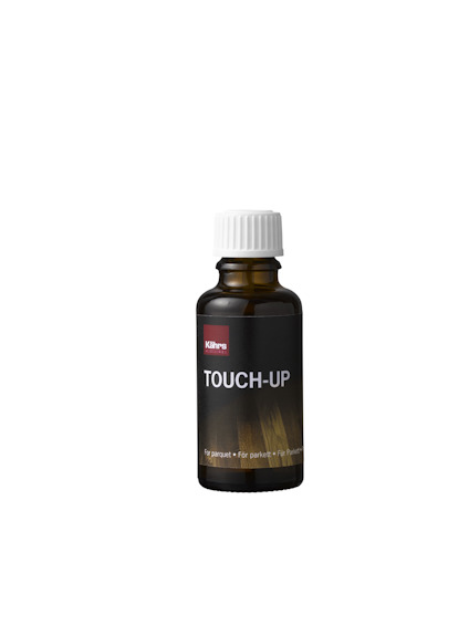 Flaska med etikett: "Kährs Touch-Up", brun vätska, vit kork.